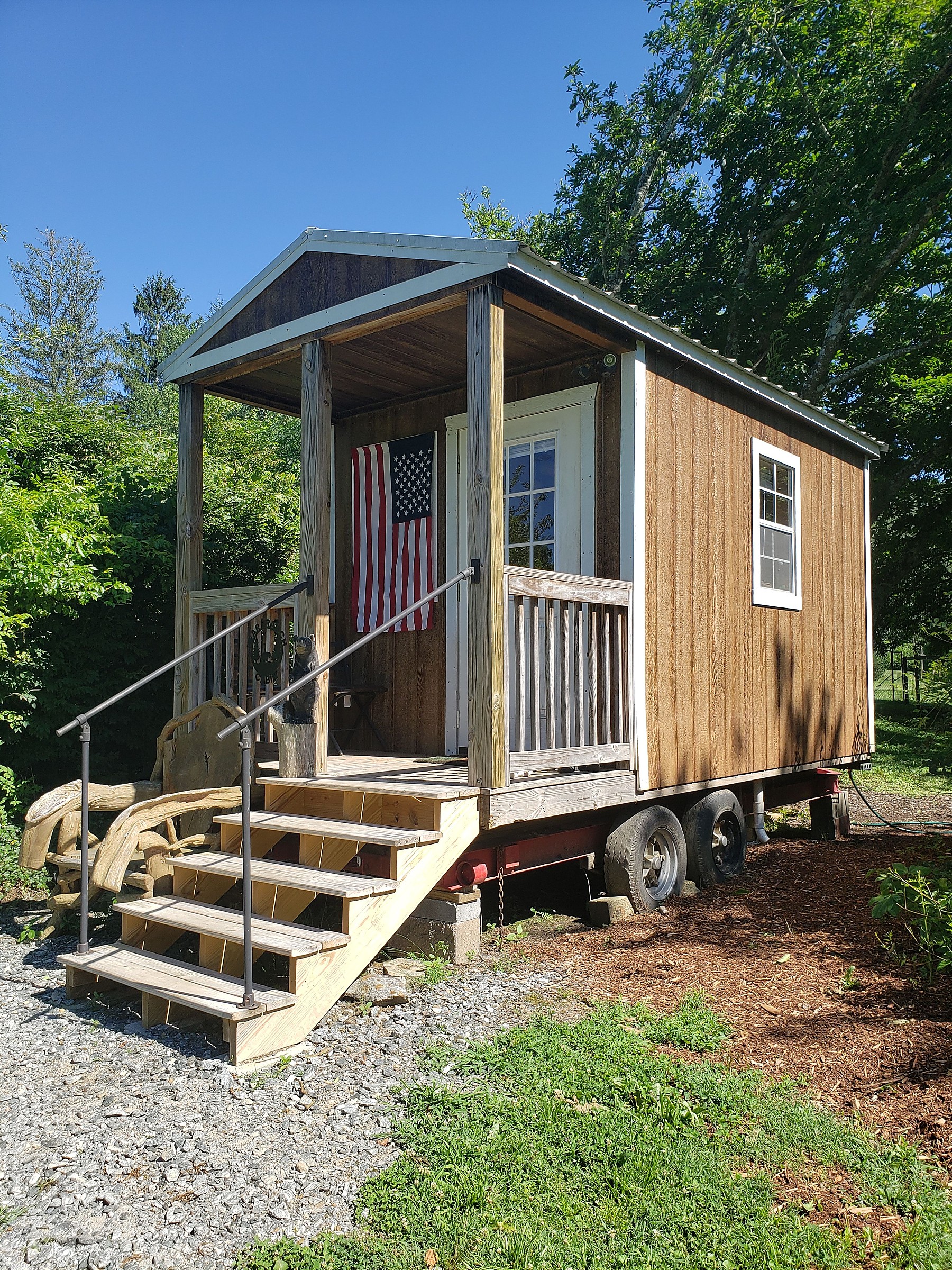 Compact tiny home mounted on a road trailer